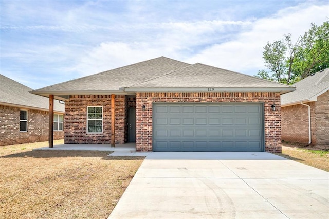 ranch-style house featuring a shingled roof, brick siding, driveway, and an attached garage