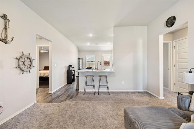 living room featuring recessed lighting, baseboards, and carpet floors