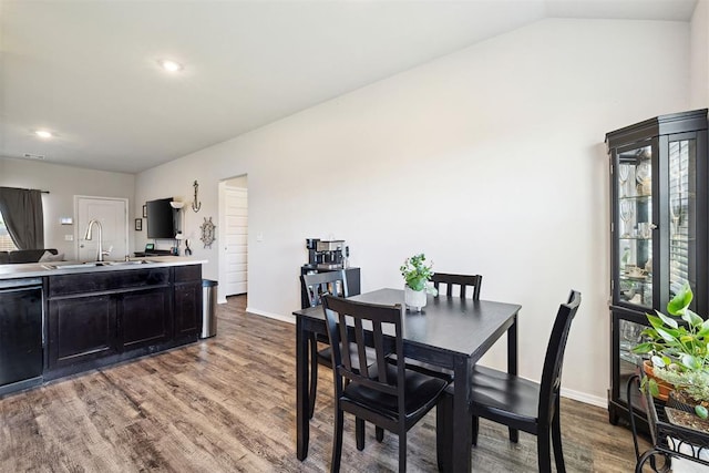 dining room featuring baseboards, recessed lighting, wood finished floors, and lofted ceiling