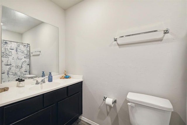 bathroom with toilet and vanity