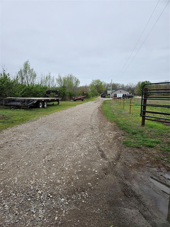 view of street with dirt driveway