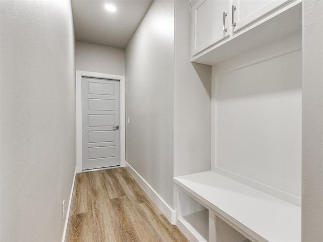 mudroom featuring light wood-type flooring and baseboards