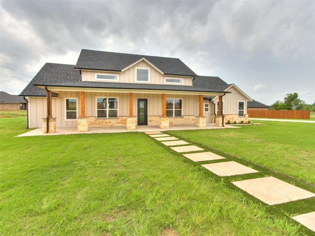 view of front of house with roof with shingles, board and batten siding, a porch, and a front lawn