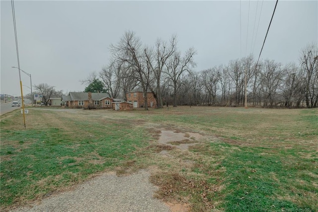 1319 S Division St, Guthrie, OK 73044 - view of green lawn featuring an outbuilding