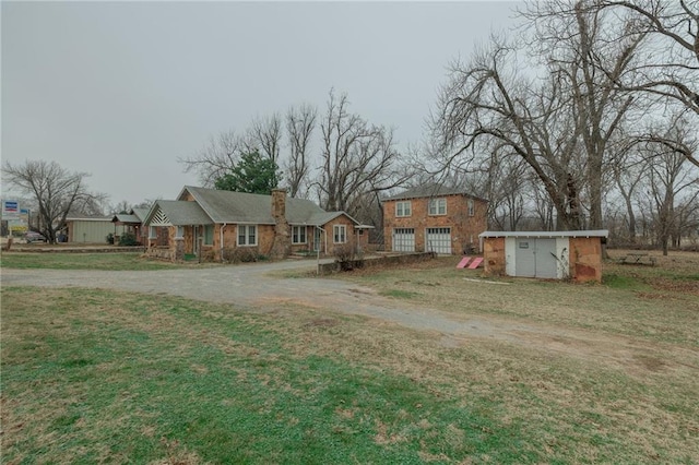 1319 S Division St, Guthrie, OK 73044 - view of front facade with driveway and a chimney