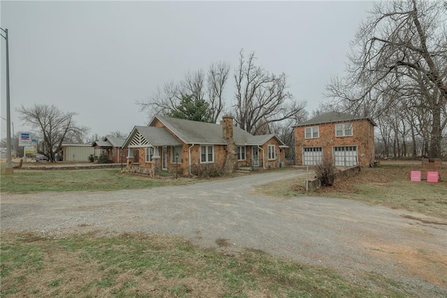 1319 S Division St, Guthrie, OK 73044 - single story home with asphalt driveway, a chimney, and covered porch