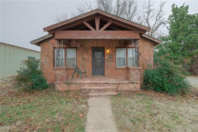 1319 S Division St, Guthrie, OK 73044 - bungalow with a porch and stone siding