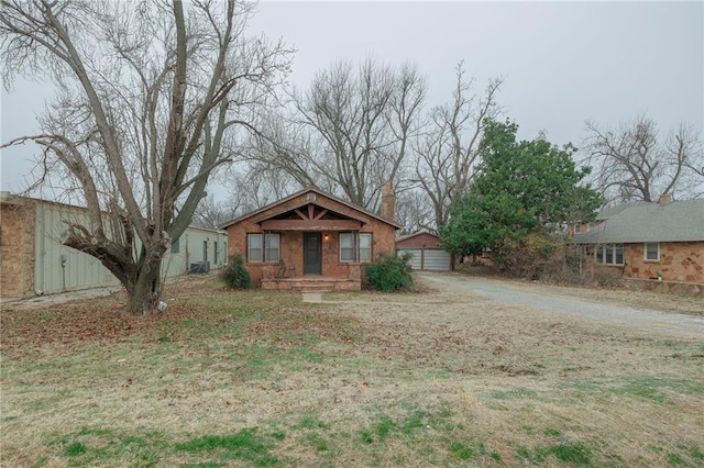 1319 S Division St, Guthrie, OK 73044 - bungalow-style home featuring an outdoor structure, a garage, and central AC unit