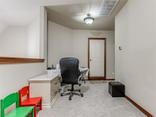 carpeted home office featuring visible vents and baseboards