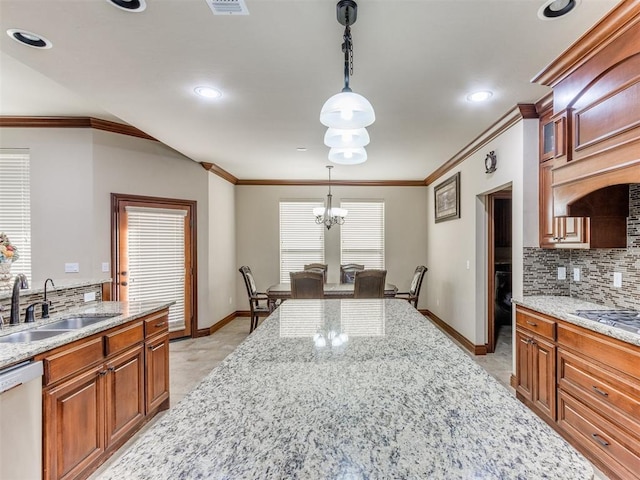 kitchen with stainless steel dishwasher, glass insert cabinets, brown cabinetry, a sink, and backsplash