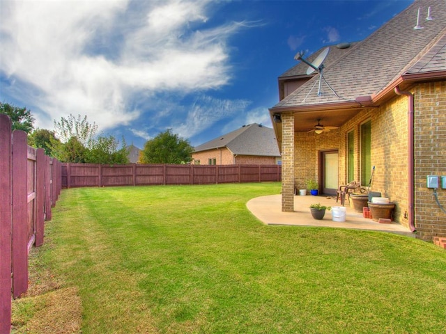 view of yard with a patio, a fenced backyard, and ceiling fan