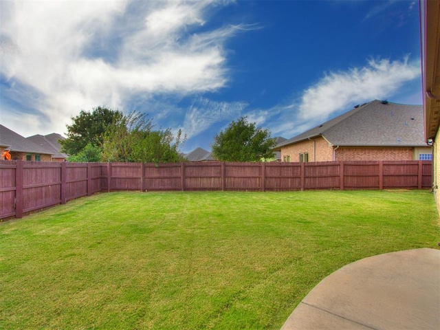 view of yard with a fenced backyard