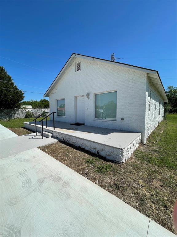 8100 NE 23rd St, Midwest City, OK 73141 - view of property exterior with brick siding and a patio area