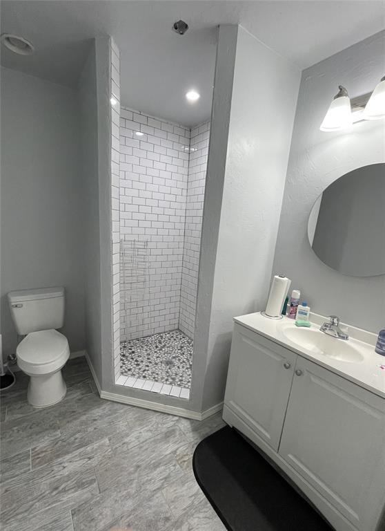 8100 NE 23rd St, Midwest City, OK 73141 - full bath featuring toilet, baseboards, a shower stall, and vanity