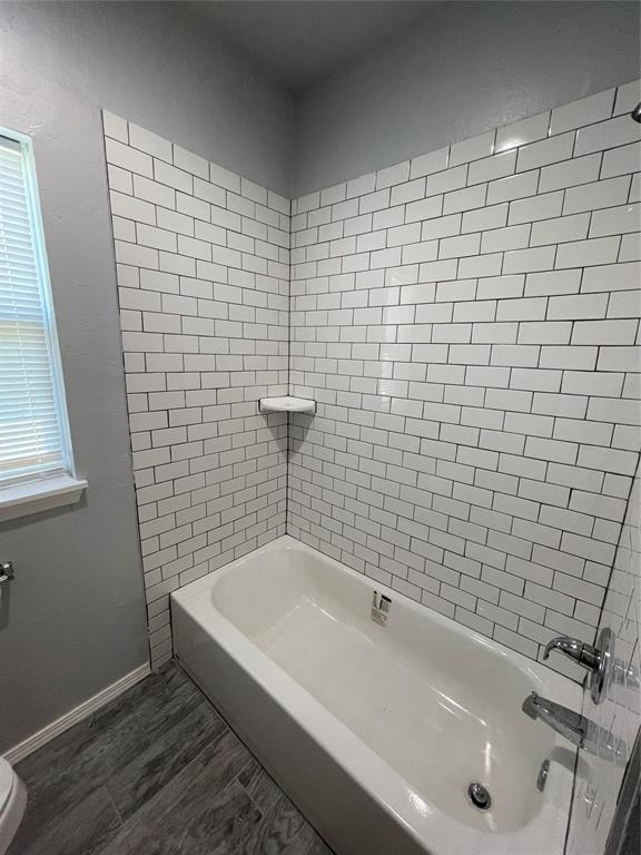 8100 NE 23rd St, Midwest City, OK 73141 - full bathroom featuring baseboards, washtub / shower combination, and plenty of natural light
