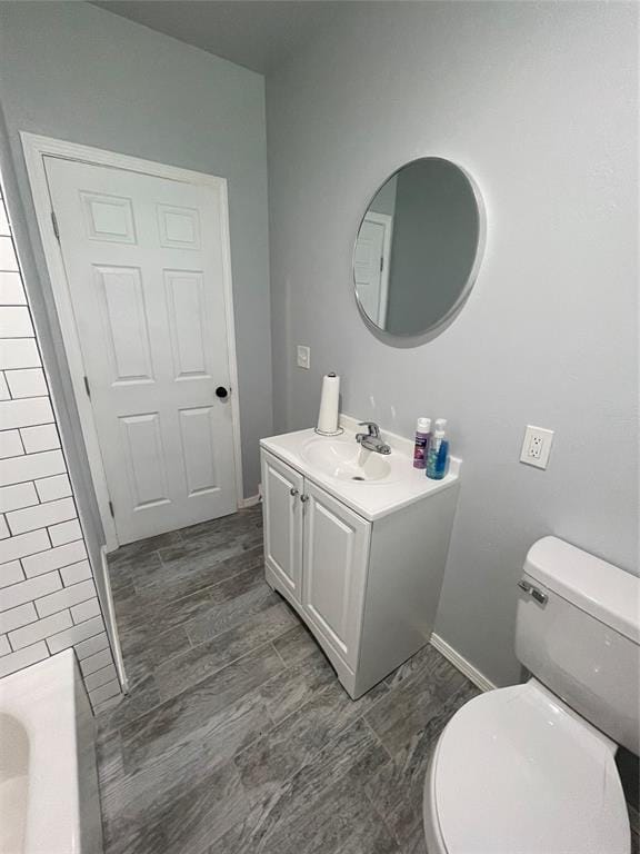8100 NE 23rd St, Midwest City, OK 73141 - bathroom with toilet, baseboards, and vanity