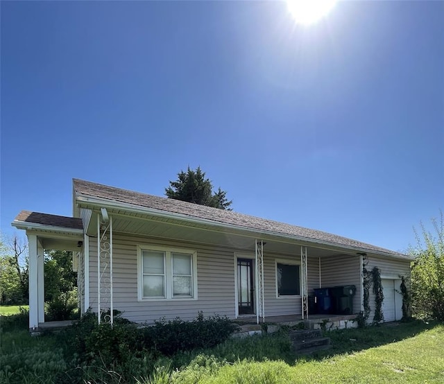 8100 NE 23rd St, Midwest City, OK 73141 - view of front of property with a garage, covered porch, and a front lawn