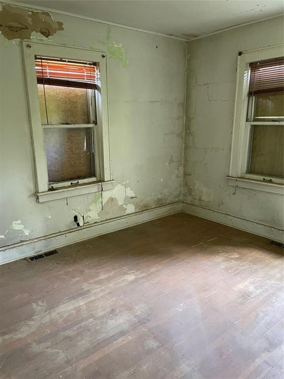8100 NE 23rd St, Midwest City, OK 73141 - spare room featuring baseboards, wood finished floors, and visible vents