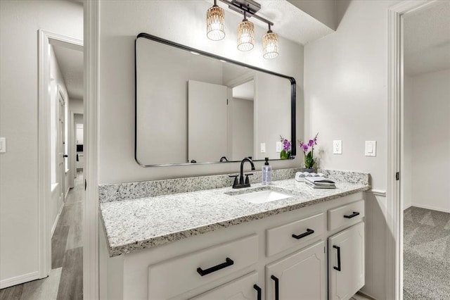 10908 Bel Air Pl, Oklahoma City, OK 73120 - bathroom featuring baseboards, vanity, and wood finished floors