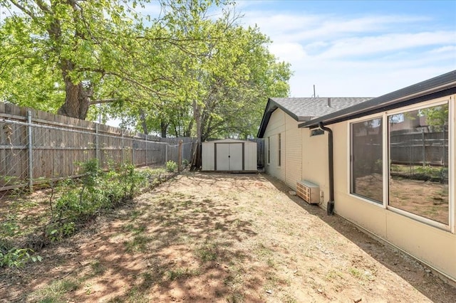 10908 Bel Air Pl, Oklahoma City, OK 73120 - view of yard with a fenced backyard, an outbuilding, and a storage shed