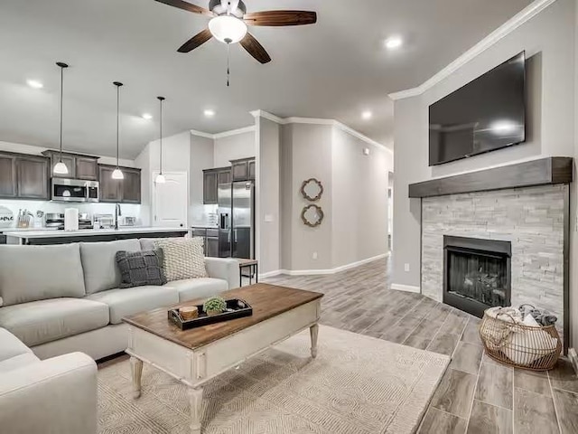 living room with recessed lighting, light wood-style flooring, a ceiling fan, and ornamental molding