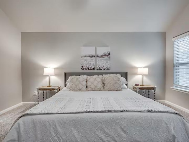 carpeted bedroom featuring baseboards