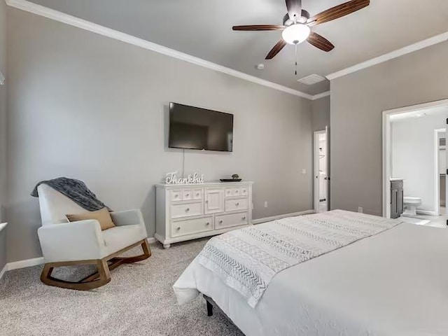 bedroom featuring carpet floors, crown molding, baseboards, and ensuite bathroom