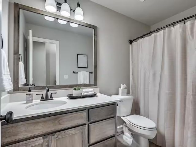 bathroom with toilet and vanity