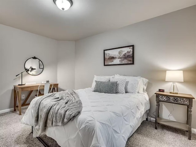 carpeted bedroom featuring baseboards