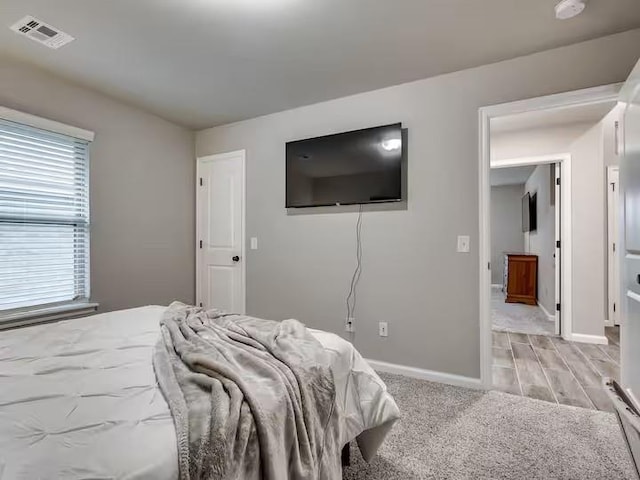 bedroom with visible vents and baseboards