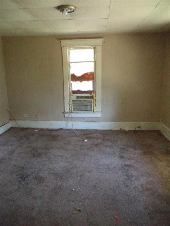 708 E Harrison Ave, Guthrie, OK 73044 - unfurnished room featuring baseboards, carpet floors, and cooling unit