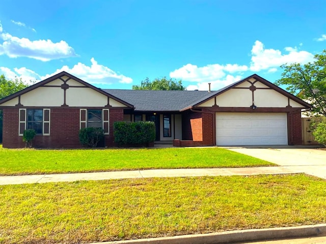 613 NE 15th St, Moore, OK 73160 - view of front of house featuring an attached garage, driveway, a front lawn, and brick siding