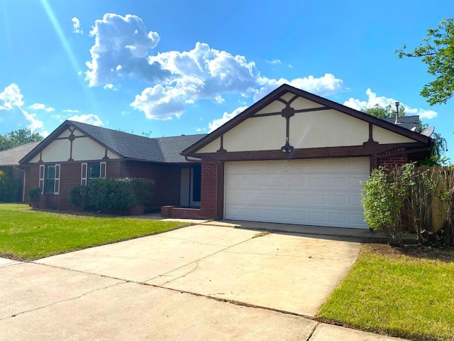 613 NE 15th St, Moore, OK 73160 - view of front of home featuring brick siding, a garage, a front yard, and driveway