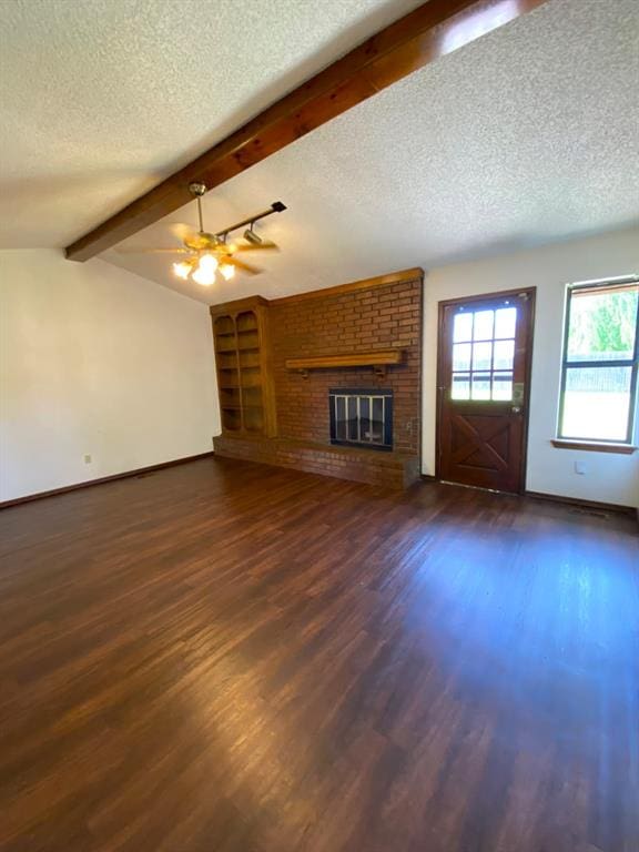 613 NE 15th St, Moore, OK 73160 - unfurnished living room with a textured ceiling, dark wood finished floors, a fireplace, baseboards, and ceiling fan