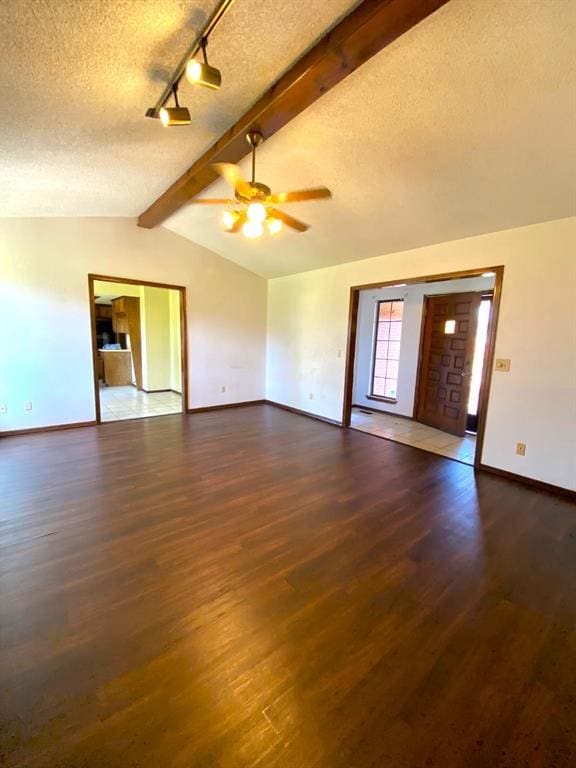 613 NE 15th St, Moore, OK 73160 - unfurnished living room featuring baseboards, wood finished floors, a textured ceiling, and ceiling fan