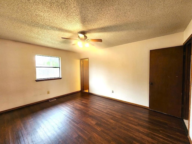 613 NE 15th St, Moore, OK 73160 - unfurnished room with wood finished floors, a ceiling fan, a textured ceiling, and baseboards