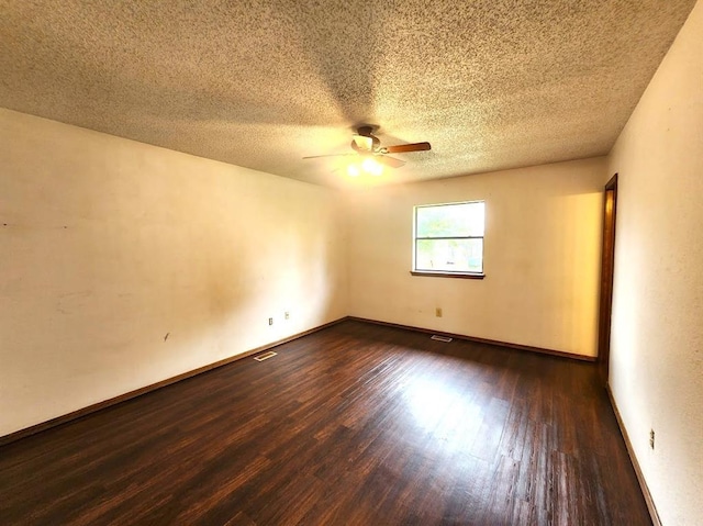 613 NE 15th St, Moore, OK 73160 - empty room with a ceiling fan, dark wood-type flooring, a textured ceiling, and baseboards
