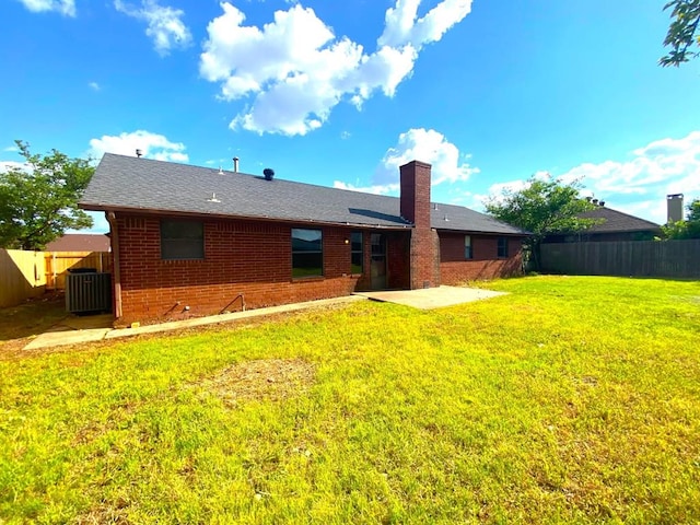 613 NE 15th St, Moore, OK 73160 - rear view of property with brick siding, a patio, a chimney, and central AC unit