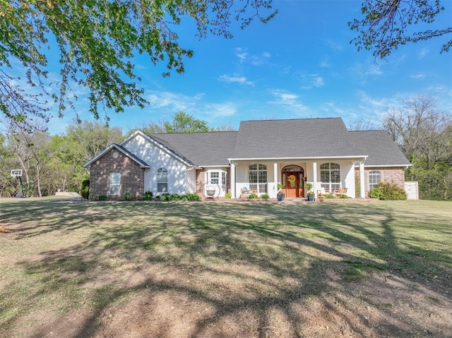 2400 Lost Lake Ln, Yukon, OK 73099 - view of front of house with covered porch, a front yard, and brick siding