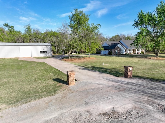 2400 Lost Lake Ln, Yukon, OK 73099 - view of front of property featuring a front lawn, an outbuilding, driveway, and a detached garage