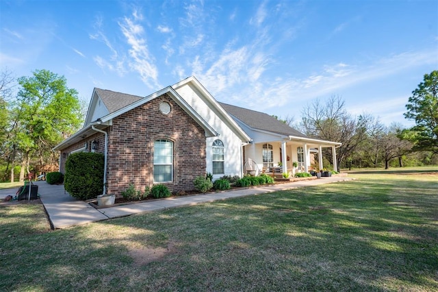 2400 Lost Lake Ln, Yukon, OK 73099 - single story home with brick siding, a porch, and a front yard