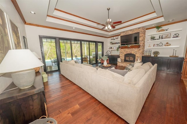 2400 Lost Lake Ln, Yukon, OK 73099 - living room featuring a raised ceiling, crown molding, ceiling fan, dark wood-type flooring, and recessed lighting