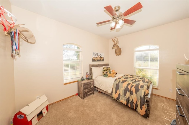 2400 Lost Lake Ln, Yukon, OK 73099 - bedroom with light carpet, baseboards, and a ceiling fan