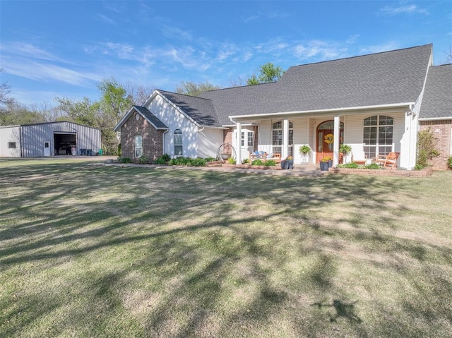 2400 Lost Lake Ln, Yukon, OK 73099 - view of front of home featuring a porch, an outbuilding, a front lawn, and a shingled roof