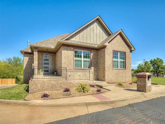 104 Rue De Montserrat, Norman, OK 73071 - craftsman inspired home with brick siding, fence, a shingled roof, and board and batten siding