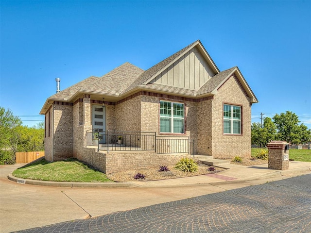 104 Rue De Montserrat, Norman, OK 73071 - view of front of house featuring brick siding, fence, and a shingled roof