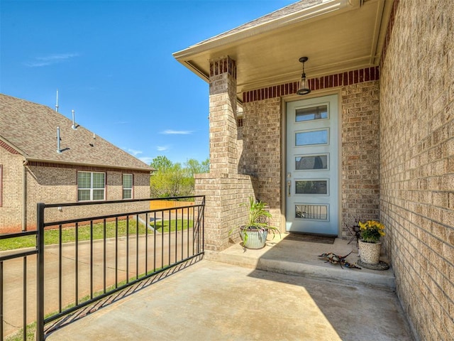 104 Rue De Montserrat, Norman, OK 73071 - property entrance featuring brick siding and a balcony