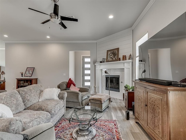 104 Rue De Montserrat, Norman, OK 73071 - living area with ornamental molding, a ceiling fan, light wood-style floors, a fireplace, and recessed lighting