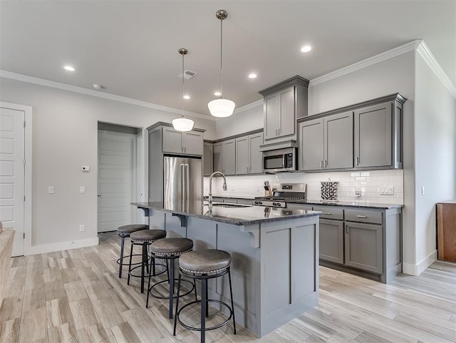 104 Rue De Montserrat, Norman, OK 73071 - kitchen with a sink, gray cabinets, appliances with stainless steel finishes, and a breakfast bar