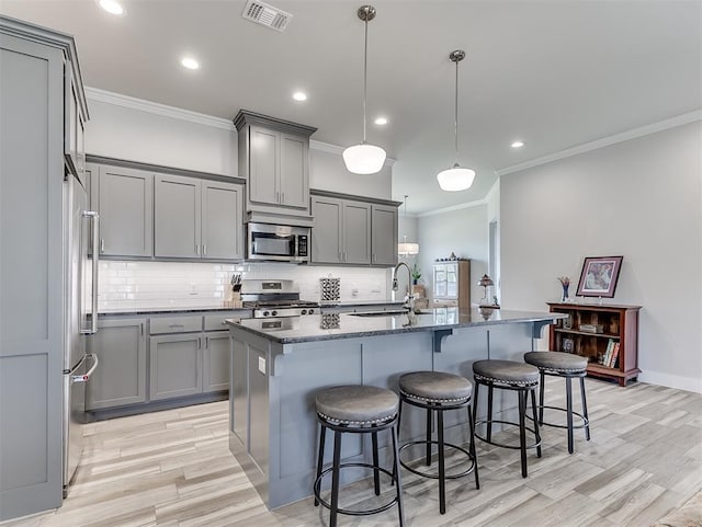 104 Rue De Montserrat, Norman, OK 73071 - kitchen featuring appliances with stainless steel finishes, a sink, gray cabinetry, and visible vents